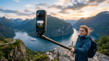 Biker holding an Insta360 camera above a dramatic fjord