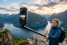 Biker holding an Insta360 camera above a dramatic fjord