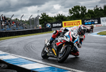 Motorcycle racer number 37 cornering on a wet track