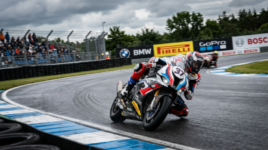 Motorcycle racer number 37 cornering on a wet track