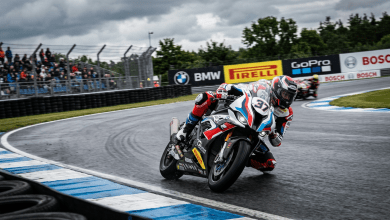 Motorcycle racer number 37 cornering on a wet track